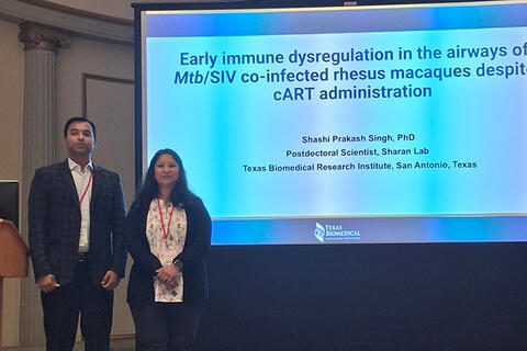 Dr. Singh and Dr. Sharan in front of presentation