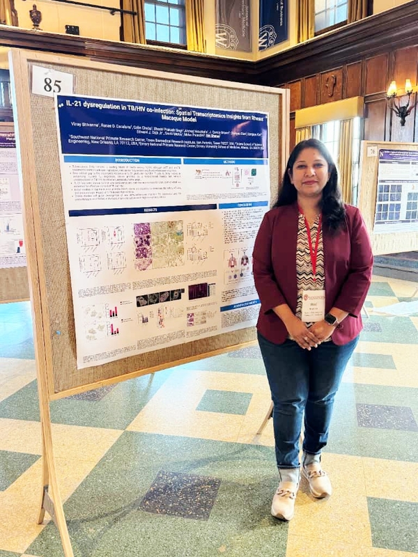 Dr. Sharan Standing with her Poster